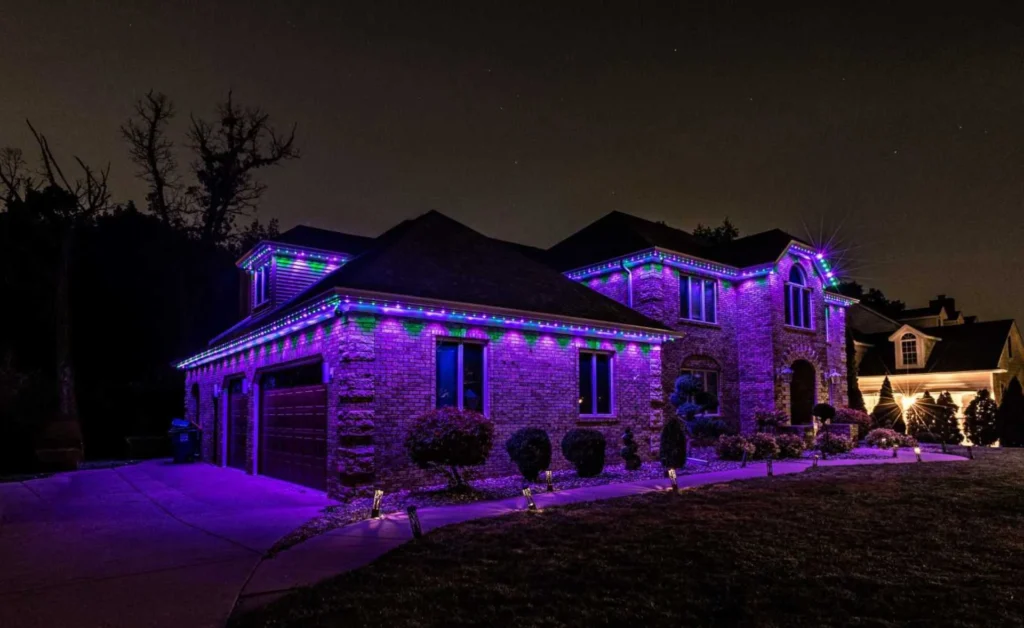 Home exterior illuminated with vivid purple Christmas lights at night